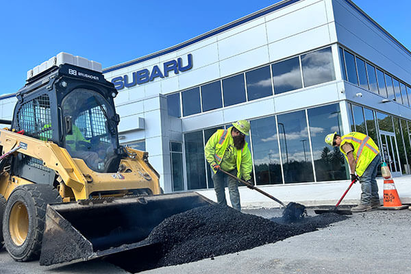 Photo of team members preparing for paving crews at a commercial construction project site