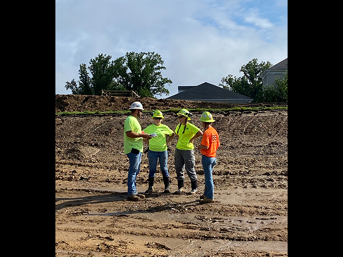interns learning from site superintendent