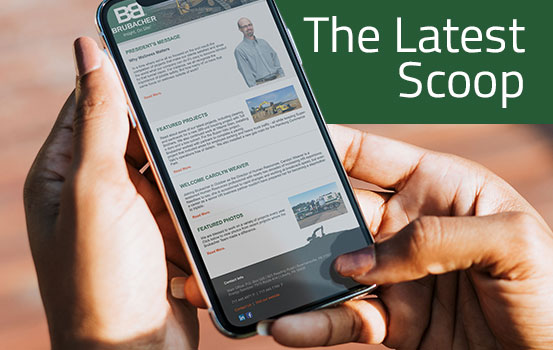 Hands holding mobile phone with Brubacher newsletter and The Latest Scoop as text overlay