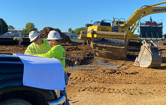 Brubacher Employees on Jobsite with Construction Vehicles in Background