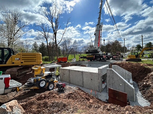 Job site of utilities and infrastructure work on a cloudy day.